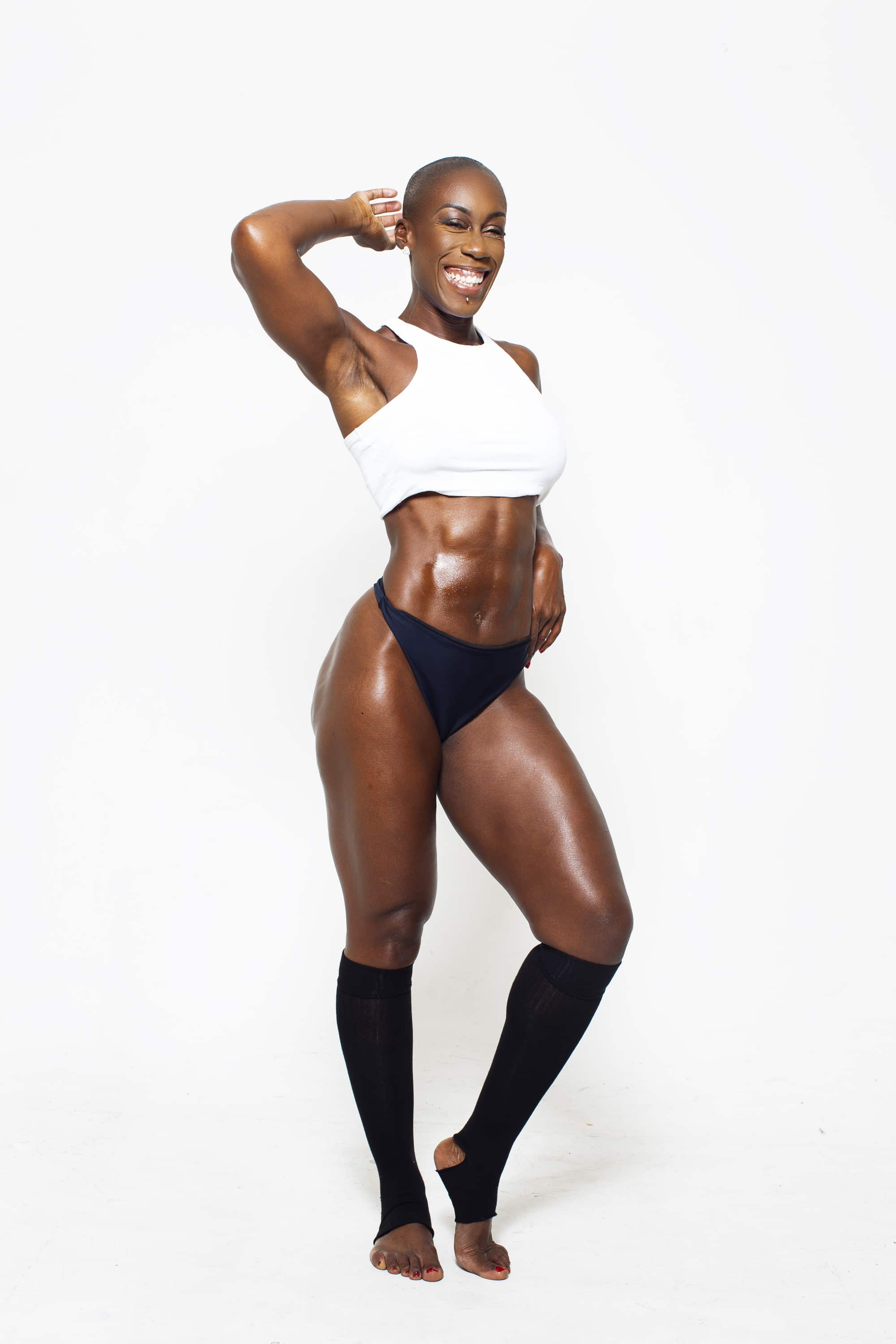 Coach Natalie posing on the floor in a studio